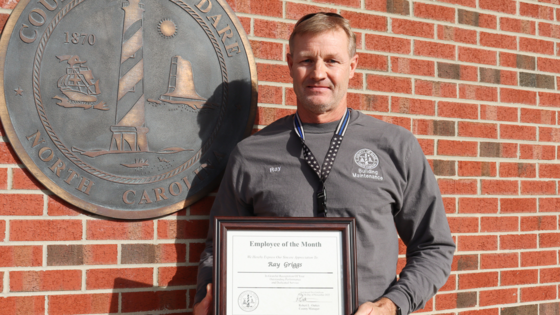 Image of Ray Griggs holding his Employee of the Month certificate.