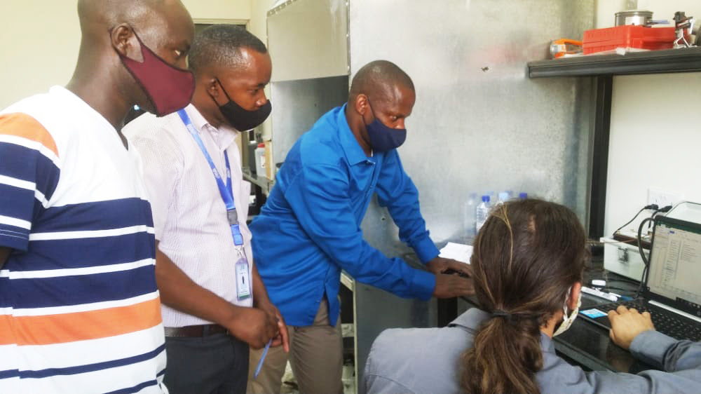 Sam Bentson trains Mr. Bernard Kabera and colleagues to use the new stove lab equipment.