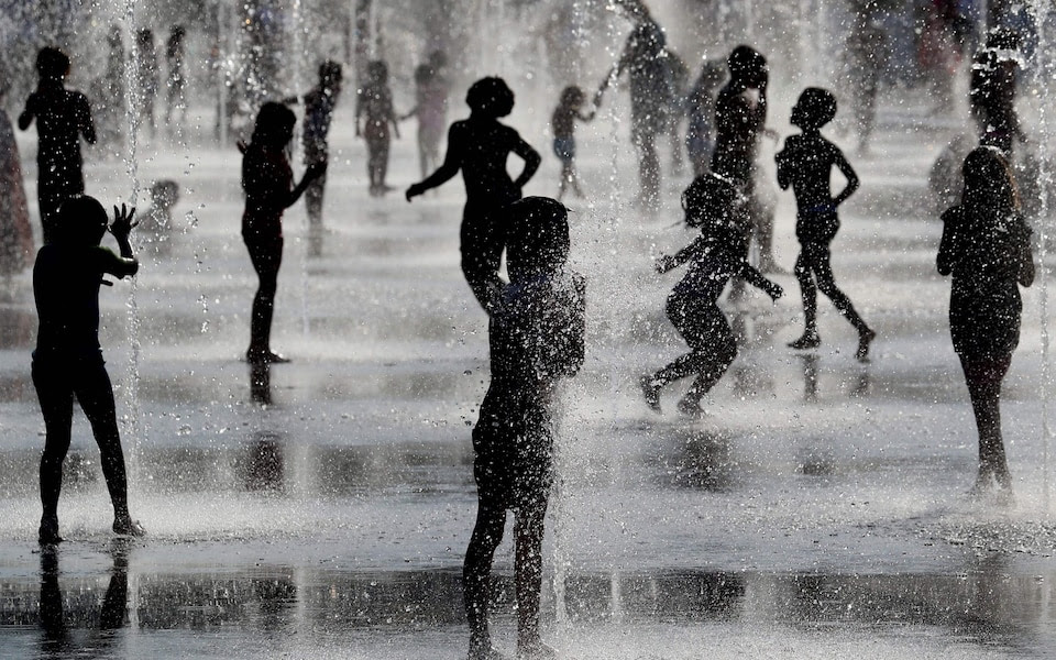 People cool off in fountains during a heatwave in Europe