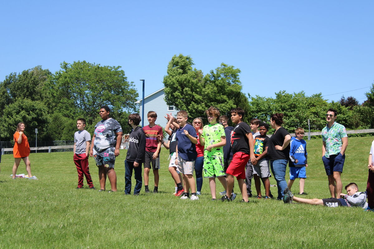 students play field day games outdoors on grass