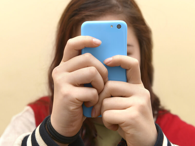 Close up of a teenager on her smartphone.