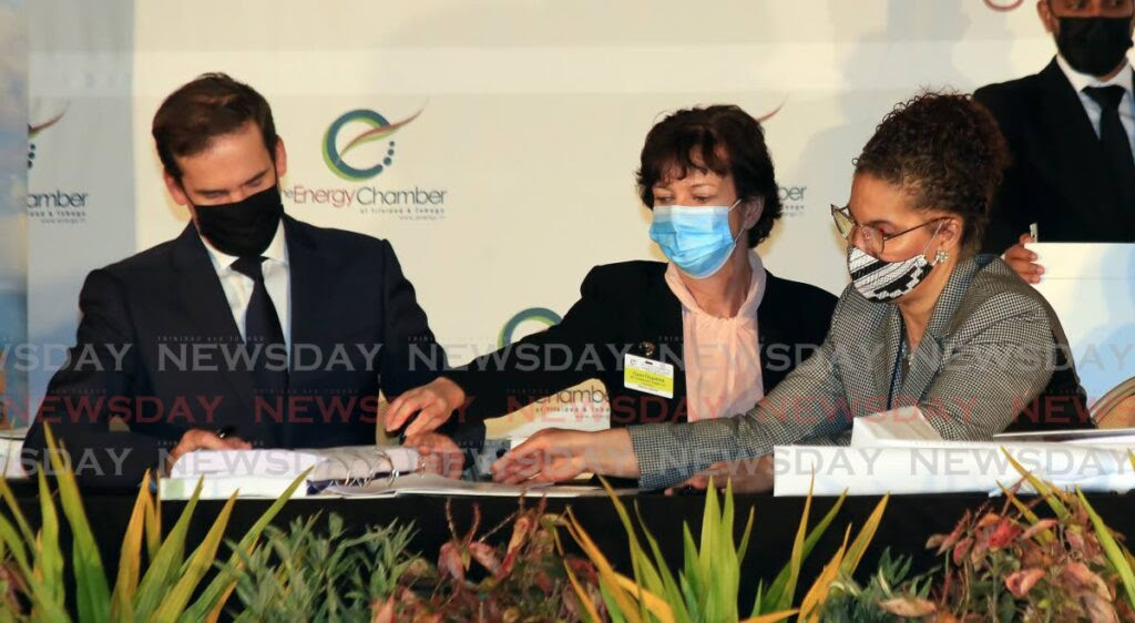 From left: Stephane Picarle, Shell TT general manager, commercial; Claire Fitzpatrick, regional president BpTT and; Louse Poy Wing, senior state counsel, Ministry of Energy, oversee the signing of deepwater exploration competitive bids on the third and final day of the TT Energy Conference, Hyatt Regency, Port of Spain, on Thursday. - SUREASH CHOLAI