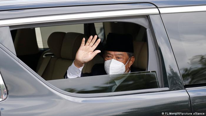 Embattled Malaysian Prime Minister Muhyiddin Yassin waves from a car while entering the National Palace to meet with the King in Kuala Lumpur, Malaysia, Monday, Aug. 16, 2021