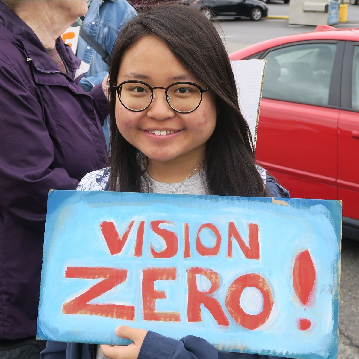 woman holding vision zero sign