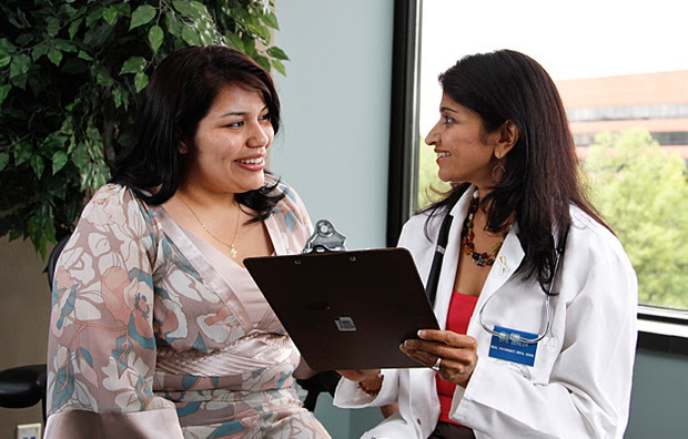 A young woman consulting with a doctor.