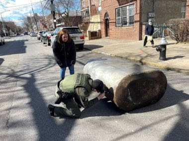 ECO inspecting metal tank in the street