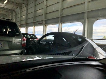 Photo from within a vehicle on the car deck of a ferry