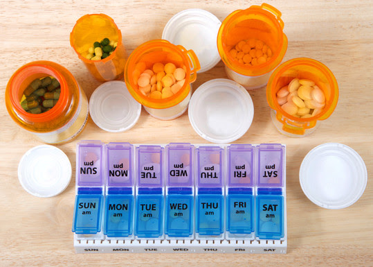 prescription medication bottles and a pill organizer