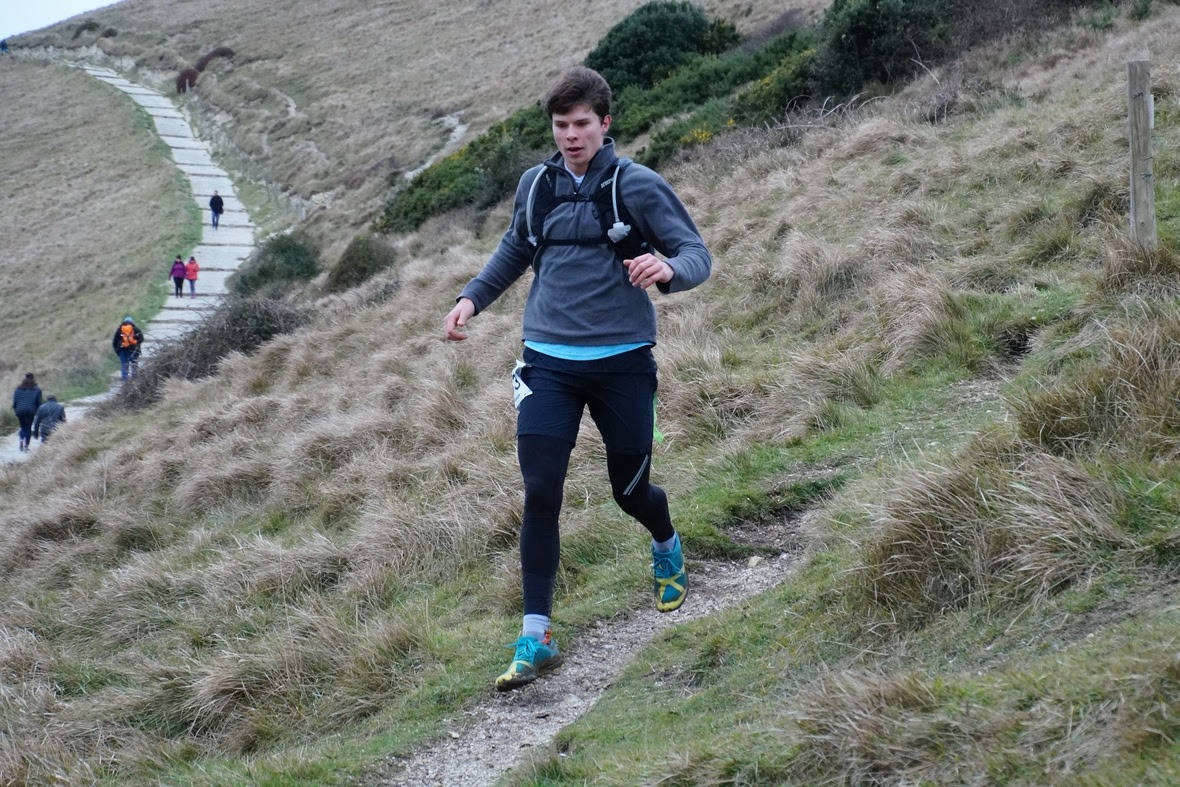 George Brill running through the hilly countryside