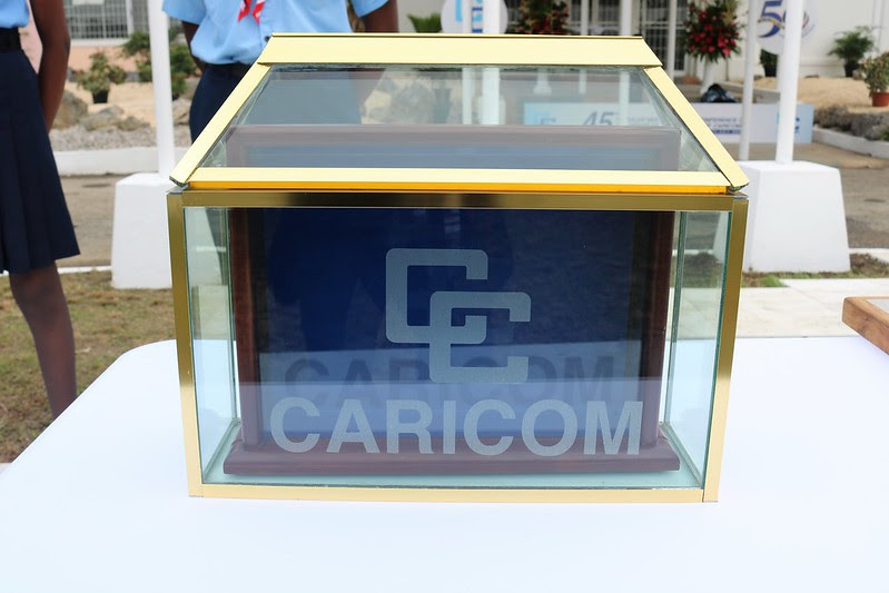 A glass box with a logo on itDescription automatically generated