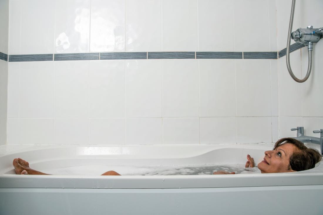 Senior taking a bath which can help alleviate rheumatoid arthritis morning stiffness