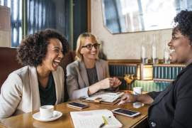 Women at Table Laughing