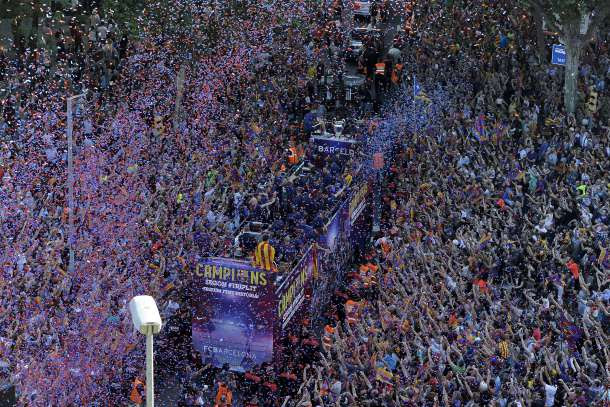 -- AFP PICTURES OF THE YEAR 2015 -- FC Barcelona players parade on a bus through the streets of Barcelona as they celebrate their victory over Juventus one day after the UEFA Champions League final football on June 7, 2015. Luis Suarez and Neymar scored second-half goals to give Barcelona a 3-1 Champions League final victory over Juventus on June 6, 2015 as the Spaniards became the first team to twice win the European treble. AFP PHOTO/ JOSEP LAGO