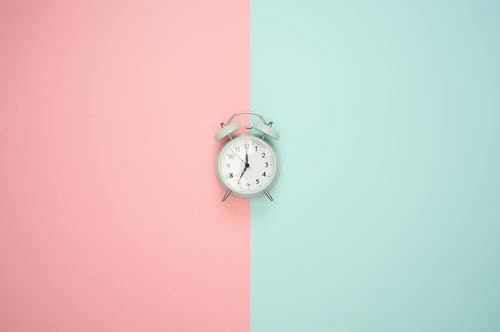 analog clock on a pink and green background