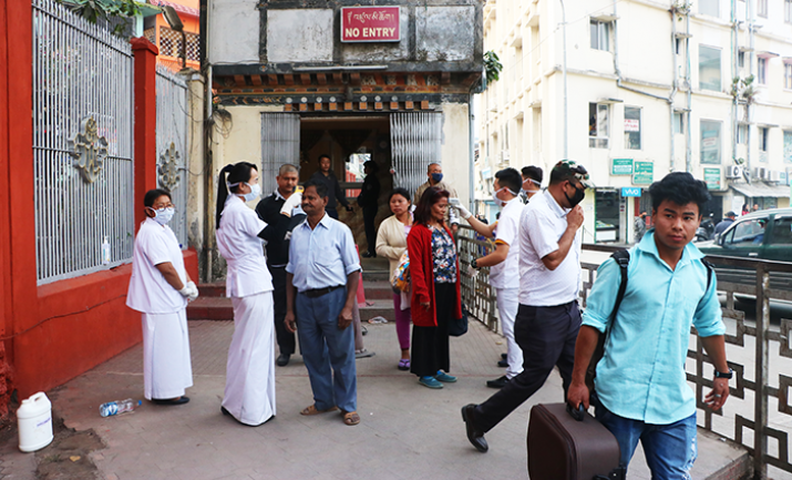 Health officials monitor the body temperatures of people crossing into Bhutan from India at the Phuentsholing border gate as a measure to prevent the spread of the novel coronavirus. From kuenselonline.com