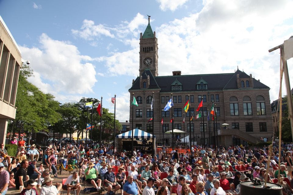A crowd of people gathered in a city square for a festival.
