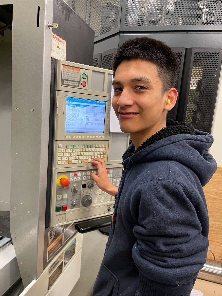 A young man working in the CNC Machining Tech youth apprenticeship