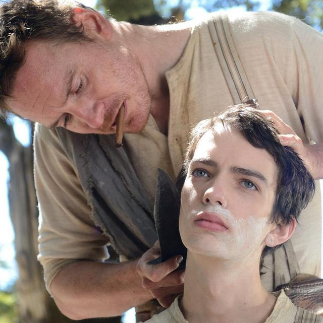 Fassbender shaves a young man's face with a knife
