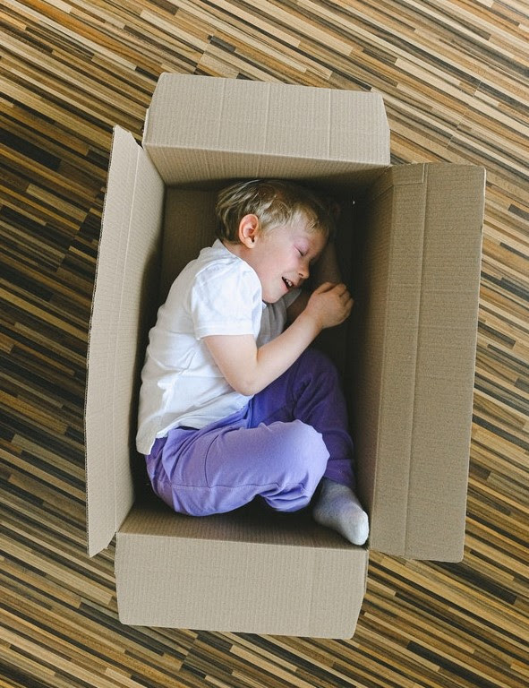 boy hiding in box