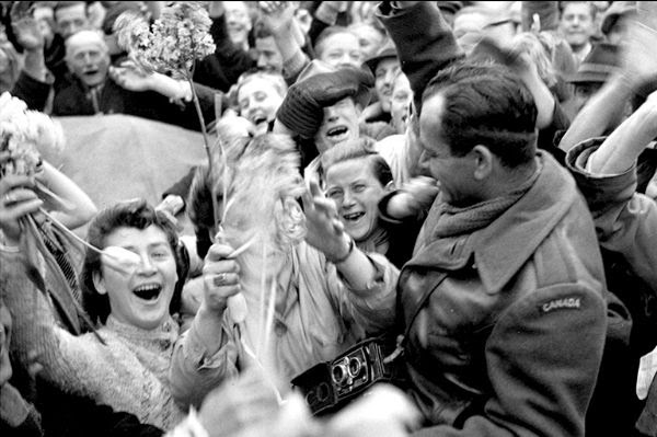 Dutch citizens celebrate liberation with a Canadian soldier.