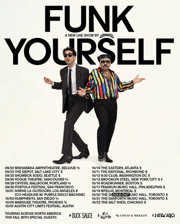 Two men walking in front of a posterDescription automatically generated with low confidence