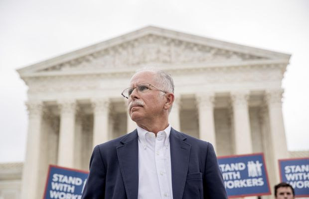Plaintiff Mark Janus stands outside the Supreme Court after the court rules in a setback for organized labor that states can&#39;t force government workers to pay union fees, Wednesday, June 27, 2018, in Washington. (AP Photo/Andrew Harnik)