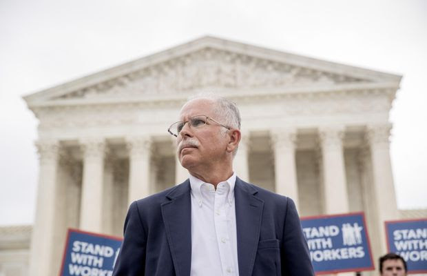 Plaintiff Mark Janus stands outside the Supreme Court after the court rules in a setback for organized labor that states can't force government workers to pay union fees, Wednesday, June 27, 2018, in Washington. (AP Photo/Andrew Harnik)