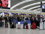 People queue at ticket machines at Heathrow airport in London, Wednesday, March 18, 2020. For most people, the new coronavirus causes only mild or moderate symptoms, such as fever and cough. For some, especially older adults and people with existing health problems, it can cause more severe illness, including pneumonia. (AP Photo/Frank Augstein)