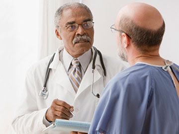 doctor talking with patient in gown