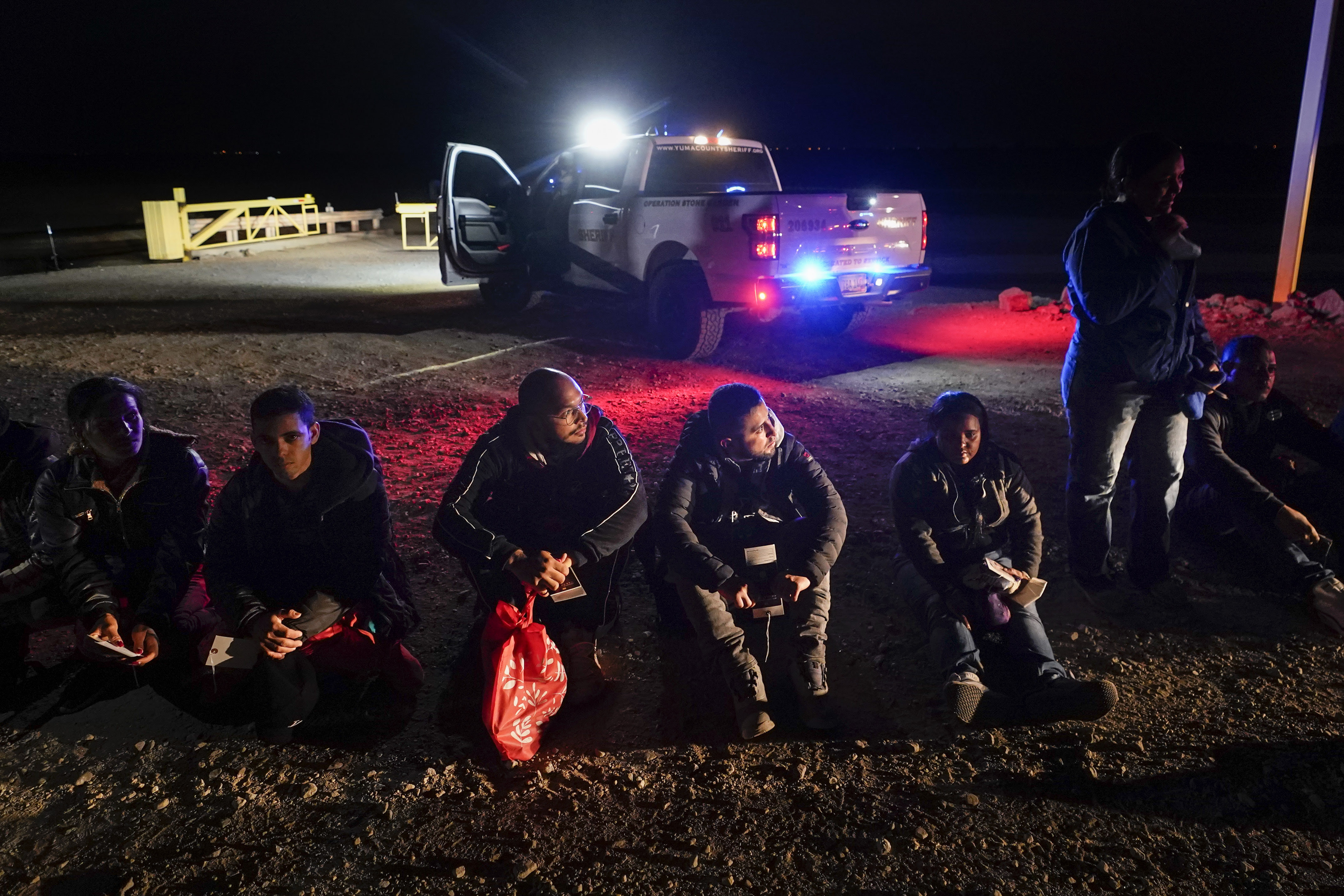 Migrants wait to be processed after crossing the border, Jan. 6, 2023, near Yuma, Ariz. A federal judge on Tuesday, July 25, blocked a rule that allows immigration authorities to deny asylum to migrants who arrive at the U.S.-Mexico border without first applying online or seeking protection in a country they passed through. But the judge delayed his ruling from taking effect immediately to give the administration time to appeal. Migrants wait to be processed after crossing the border, Jan. 6, 2023, near Yuma, Ariz. A federal judge on Tuesday, July 25, blocked a rule that allows immigration authorities to deny asylum to migrants who arrive at the U.S.-Mexico border without first applying online or seeking protection in a country they passed through. But the judge delayed his ruling from taking effect immediately to give the administration time to appeal.