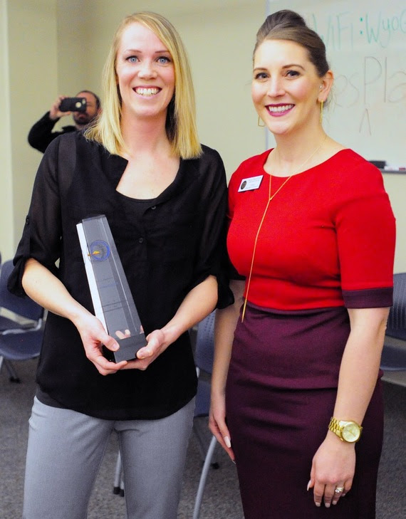 Milken Educator Award winner Shannon Hill holds her award shortly after receiving it from WDE Chief Policy Officer Megan Degenfelder.