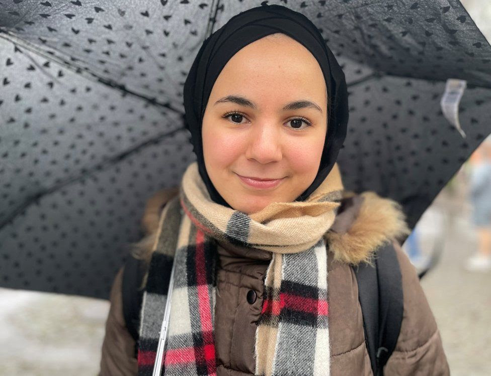 Nadia Boukdir holding an umbrella