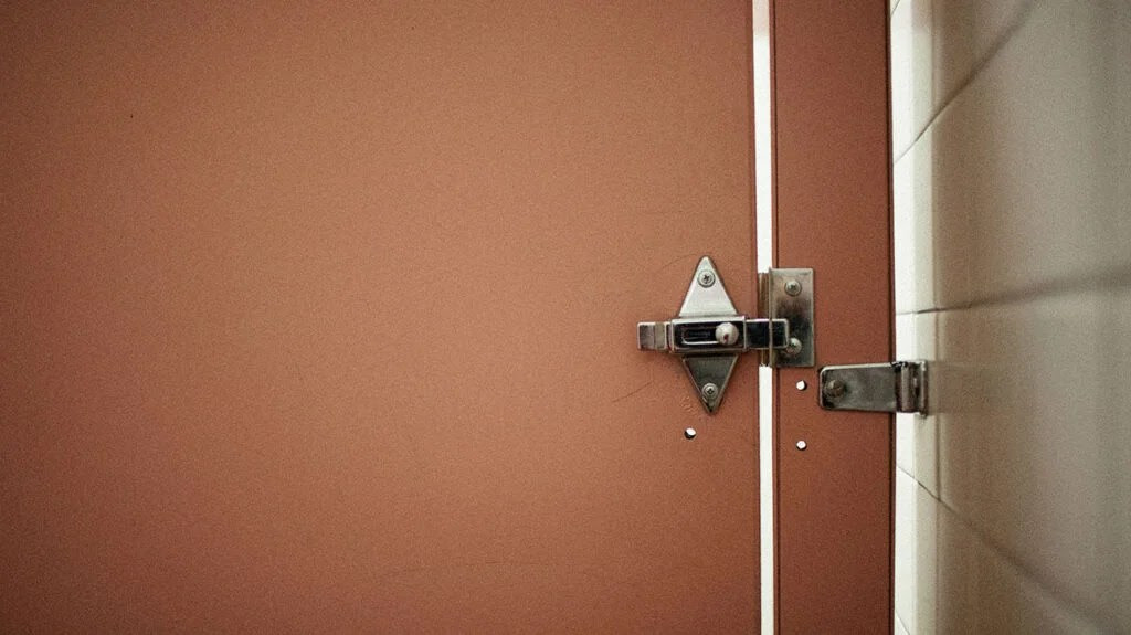 The interior of a public restroom door to accompany an article about blood in stool.
