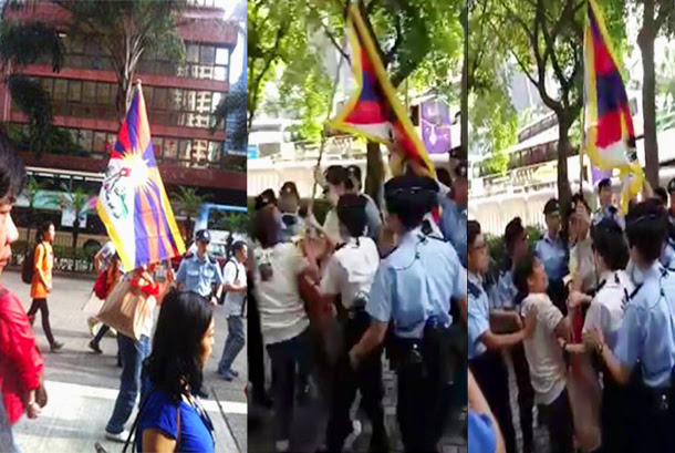 A Tibet supporter holding a Tibetan flag is mobbed by a dozen police officers who try to grab the flag from her, in Hong Kong, on May 17, 2016. Photo: TPI Tibet-Flag-Hong-Kong-China-2016