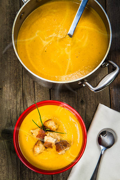 Pot And Bowl Of Homemade Butternut Squash Soup Pot And Bowl Of Homemade Butternut Squash Soup squash soup stock pictures, royalty-free photos & images
