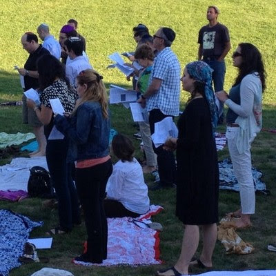 people praying in a park