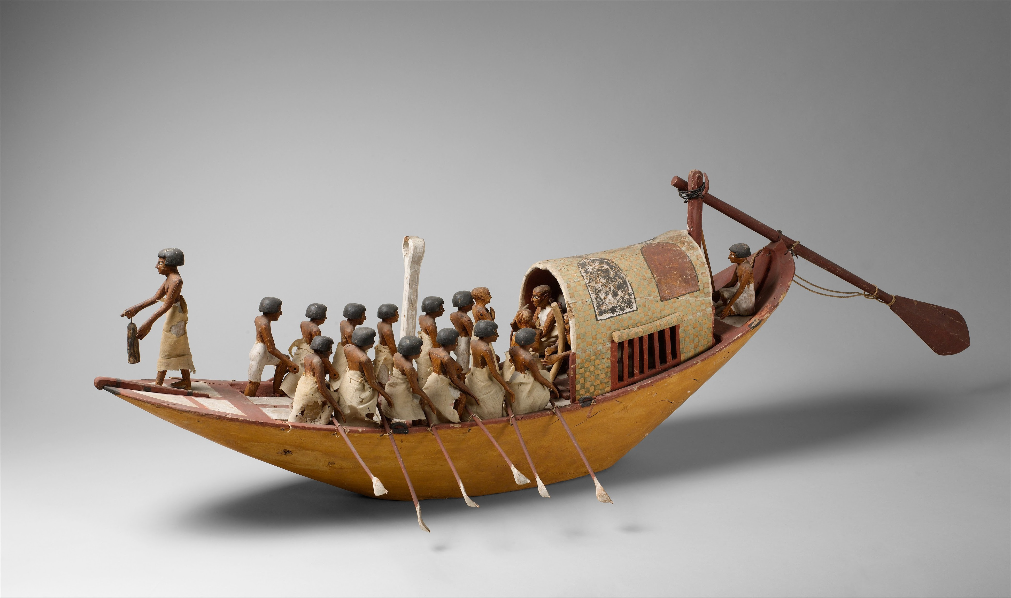 Historic sculpture of a traveling boat being rowed. Rowing art