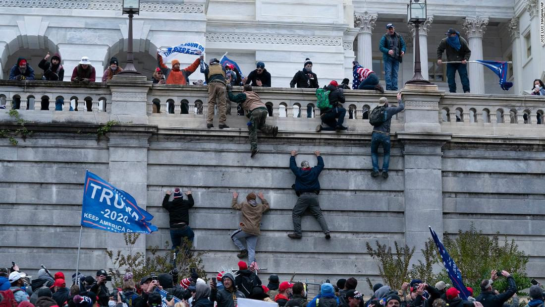 Right wing extremists scale US Capitol wall like zombies in a scene from World War Z