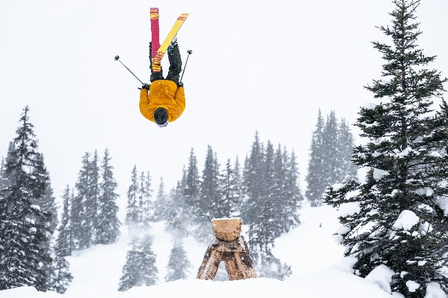 A teddy bear flies through the air on a snowboardDescription automatically generated with low confidence