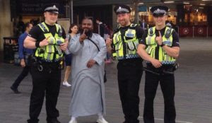 UK police officers make ISIS one-finger salute