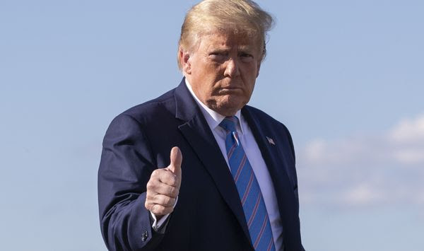 President Donald Trump gives a thumbs-up while walking across the tarmac as he boards Air Force One at Morristown Municipal Airport, Sunday, June 14, 2020, in Morristown, N.J. Trump is returning to Washington. (AP Photo/Alex Brandon)