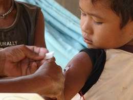 Child receiving measles vaccine in Cambodia
