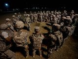 In this photo taken Aug. 17, 2010, at Camp Taji, Iraq, members of 2nd Squadron, 1st Cavalry Regiment, 4th Stryker Brigade, 2nd Infantry Division led by Lt. Col. Richard D. Heyward gather for a briefing before starting a two-day tactical road march to the Iraq-Kuwait border. They are among the last combat soldiers who will leave Iraq before the Aug. 31 deadline for ending U.S. combat operations. (AP Photo/Los Angeles Times, Carolyn Cole) 