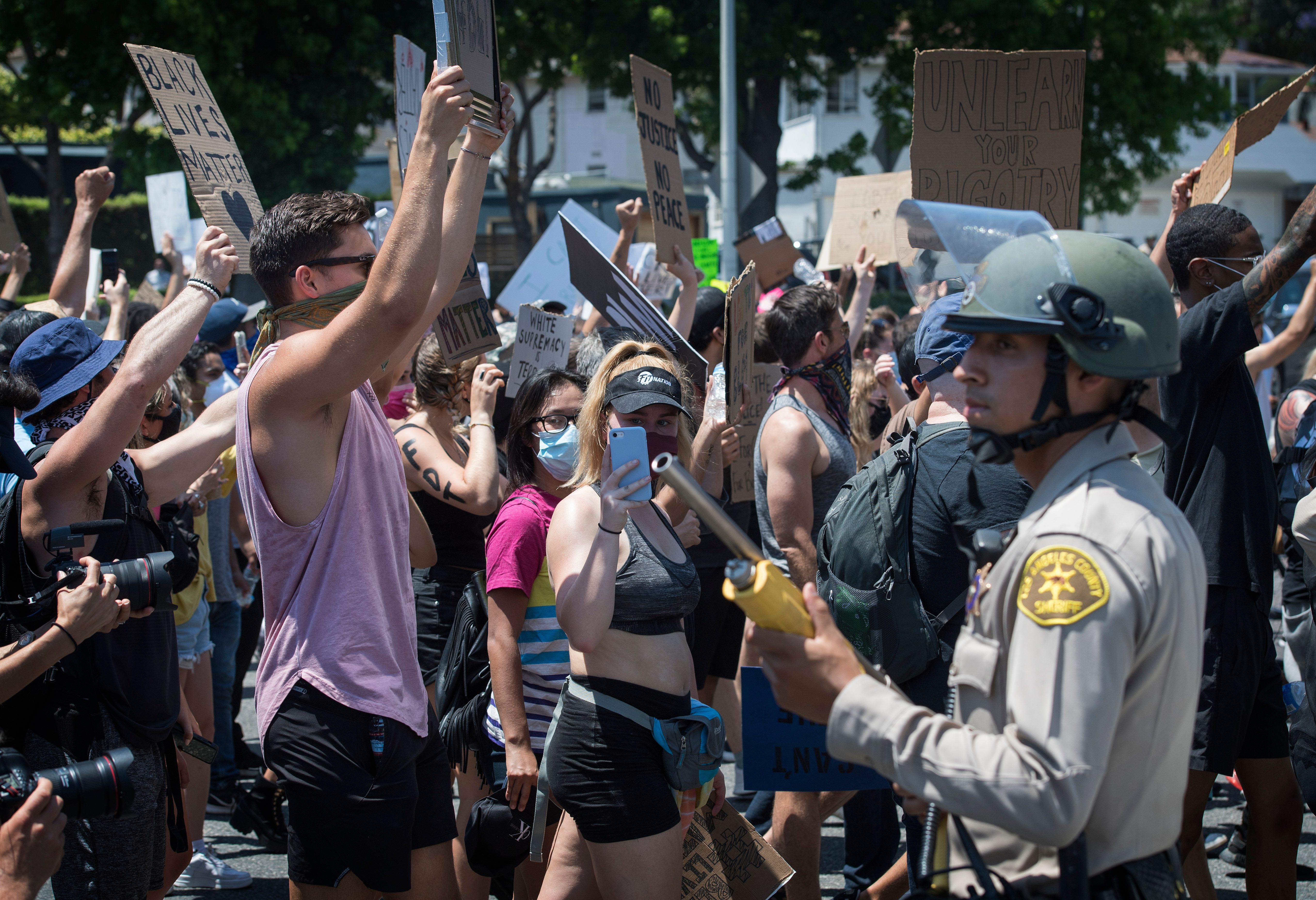 Officers from the Sheriff's Department keep watch as demonstrators continued to protest the death of George Floyd, in West Hollywood, California on June 3, 2020. - Former Minneapolis police officer Derek Chauvin, who kneeled on the neck of George Floyd who later died, will now be charged with second-degree murder, and his three colleagues will face charges of aiding and abetting second-degree murder, court documents revealed on June 3. (Photo by MARK RALSTON/AFP via Getty Images)
