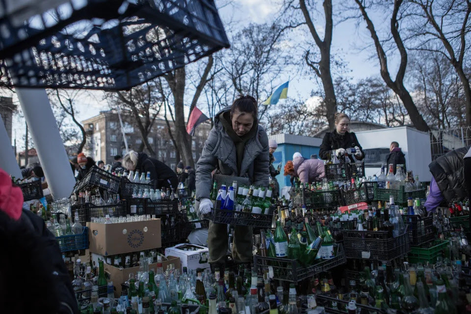 Locals gather empty bottles to make Molotov cocktails.