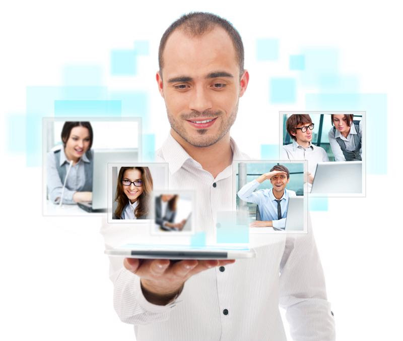 A manager is surrounded by images of his virtual team.