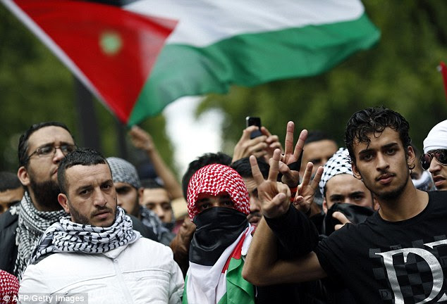 Pro-Palestinian demonstrators take to the streets of Paris on Sunday. France's socialist government has sparked uproar after it banned protests against Israeli action in Palestine
