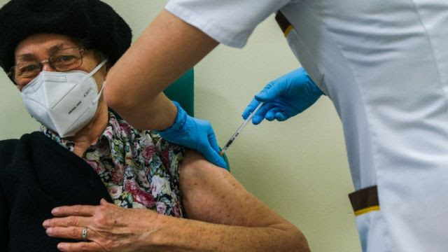 A patient receiving a vaccine in the UK