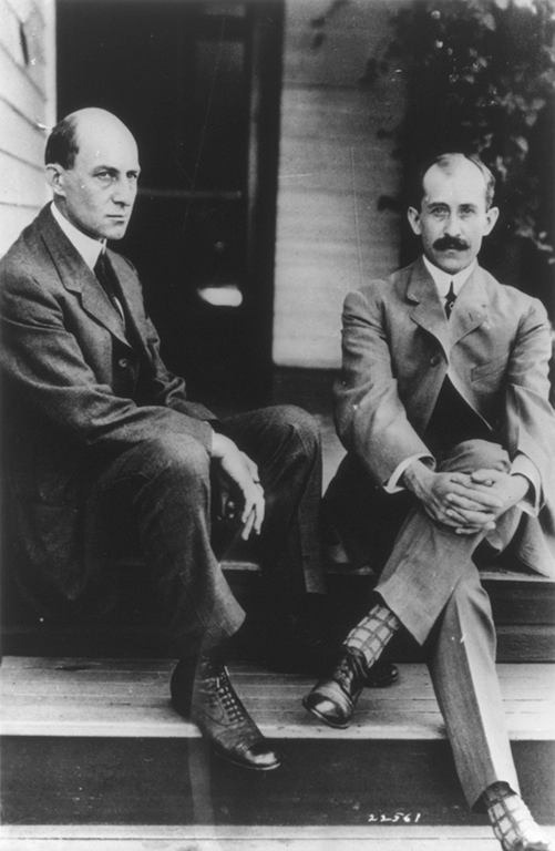 Wilbur Wright and Orville Wright seated on steps of rear porch 7 Hawthorne St. Dayton Ohio ..