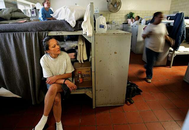 Lydia Alvarez sits on her bunk bed, which she had to cover with a prison-issue blanket. Her bed is in a converted day room shared by 38 women at the California Institution for Women in Corona, where the inmate population of 1,500 is at an all-time high.